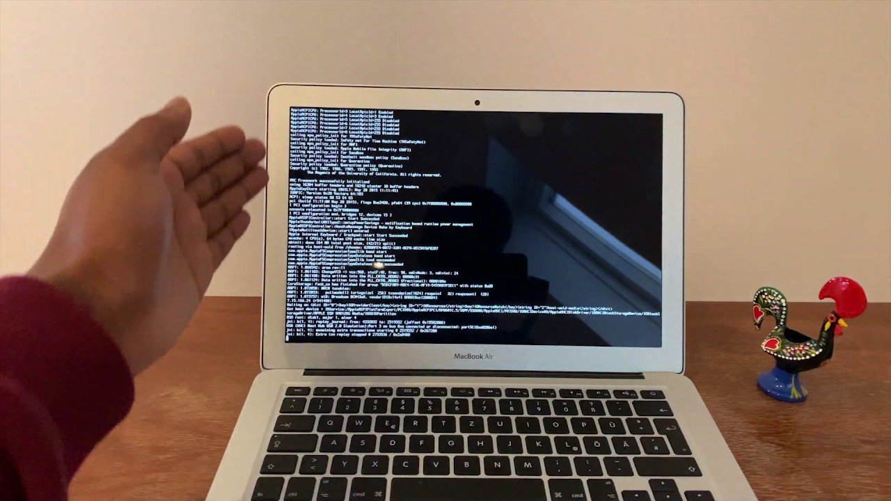 A MacBook Air screen displays the setup screen after a successful factory reset.