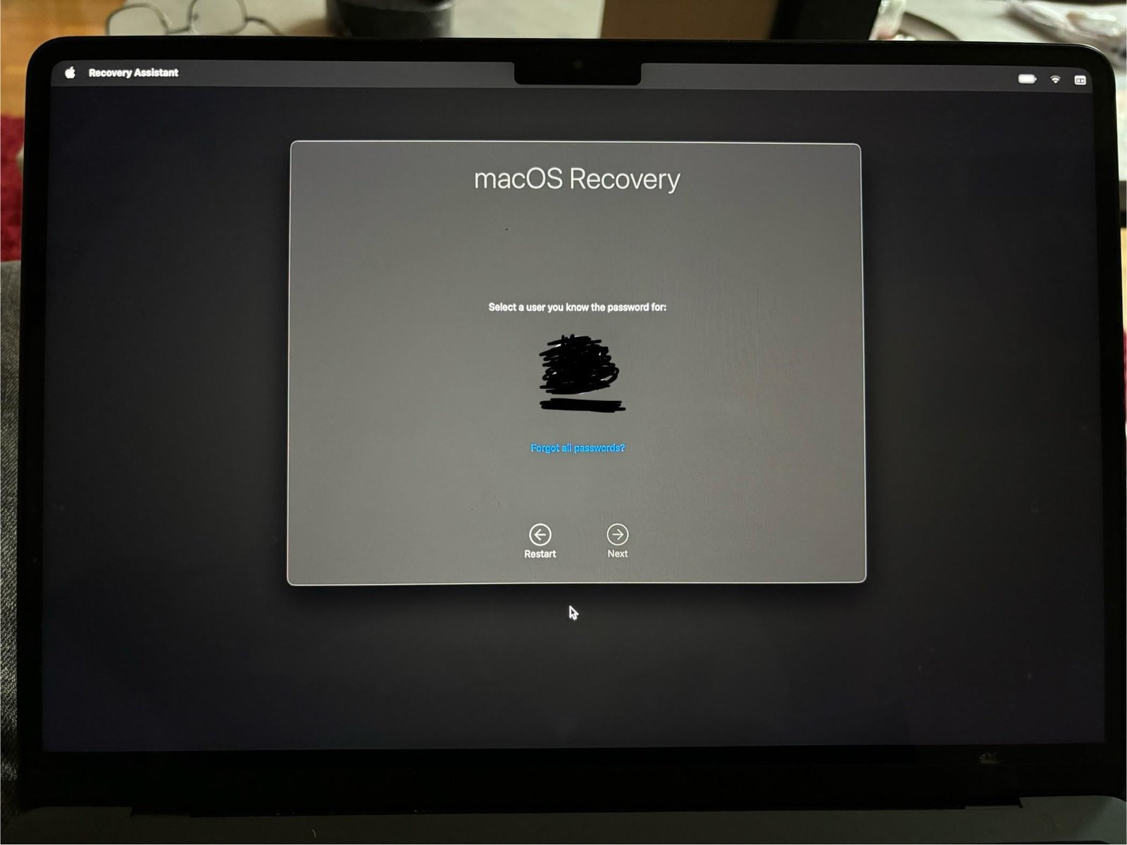 A user checks their digital account settings before performing a MacBook Air reset.