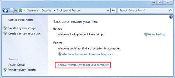 Inserting a recovery disc into an older desktop computer tower for system restoration.