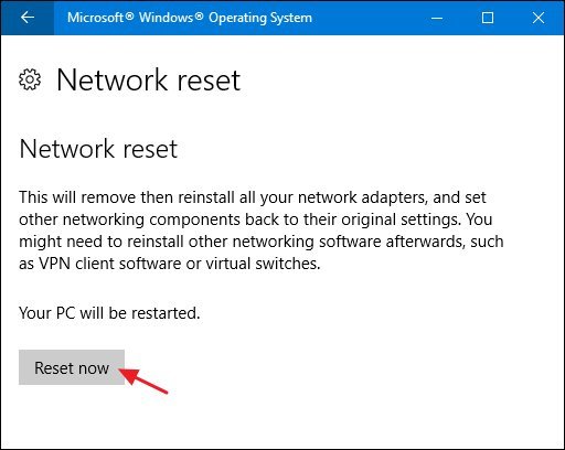 Hands typing on a laptop to begin the Windows networking reset process.