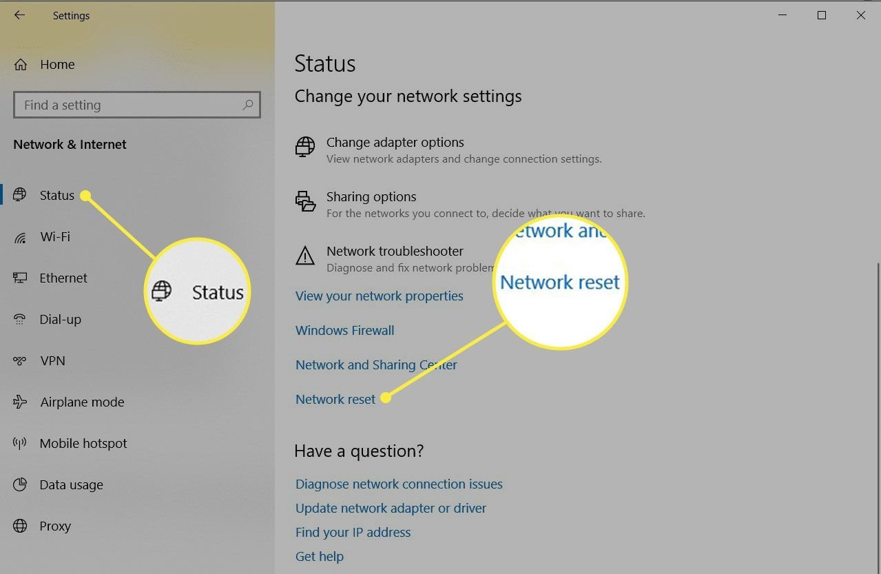 A handwritten note with Wi-Fi credentials beside a laptop to avoid networking mistakes.
