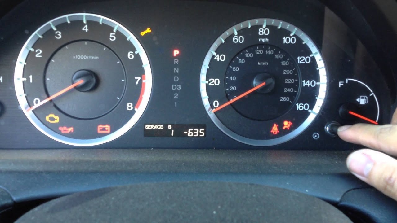 The illuminated instrument cluster of a 2008 Honda Accord showing a maintenance reminder.