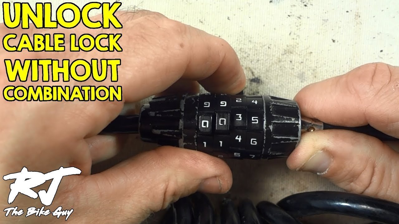 Essential tools for resetting a bike lock arranged on a clean wooden workbench.