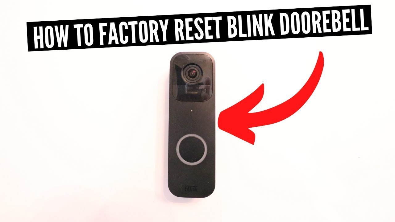 A person holding a modern smart doorbell to prepare for a device reset.
