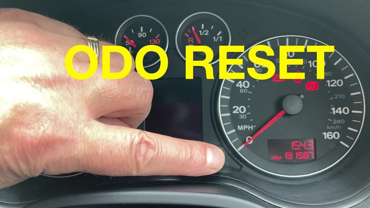 Steering wheel control buttons used for navigating car settings and trip logs.