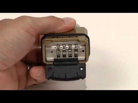 Using a small tool to manually reset a security dial lock mechanism.