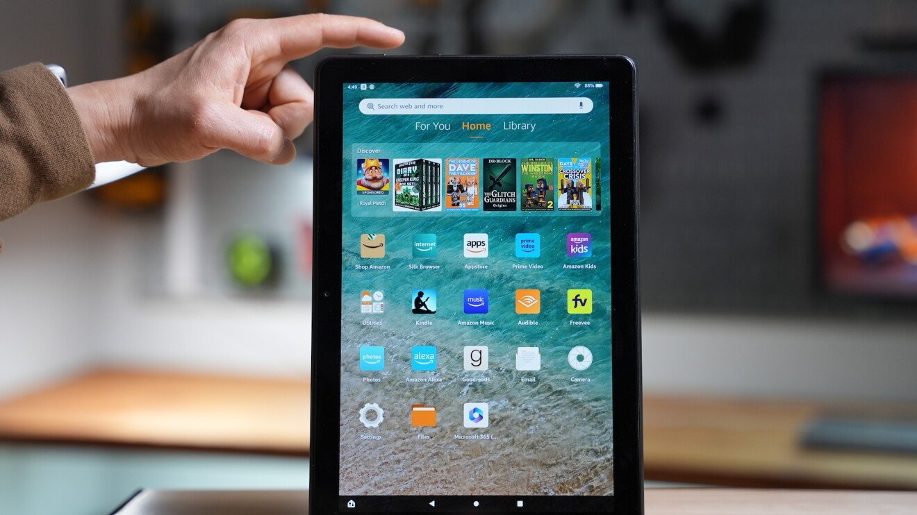 A person removes the microSD card from the tablet to prevent data loss during a reset.