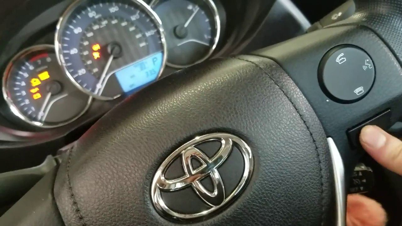 A driver's foot positioned near the brake pedal during a maintenance reset.