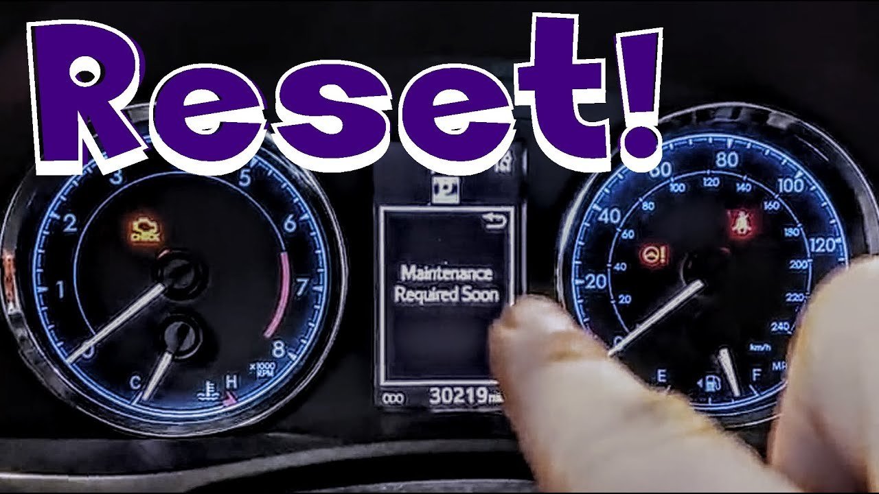 The maintenance light glowing on a modern Toyota Corolla dashboard instrument cluster.