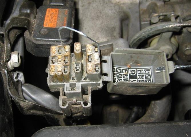 An OBD2 scan tool connected to a car for advanced diagnostic reset options.