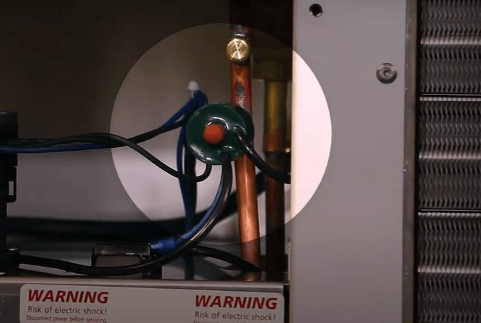Hand flipping a circuit breaker switch inside a modern home electrical panel.