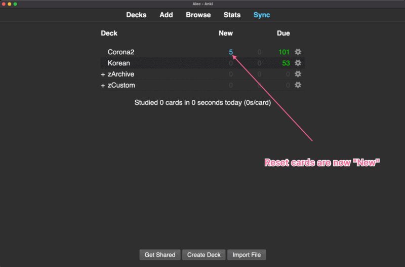 Laptop screen and planner showing study load metrics for managing an Anki deck collection.