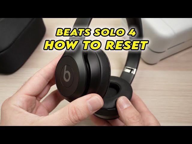 A pulsing white LED light on the side of headphones indicating a reset.