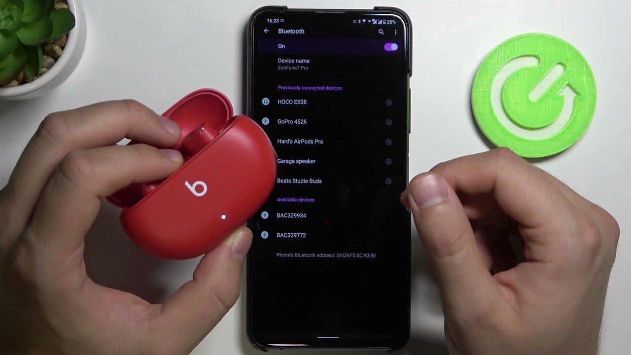 Beats Studio Buds placed near a smartphone for troubleshooting Bluetooth connection issues.
