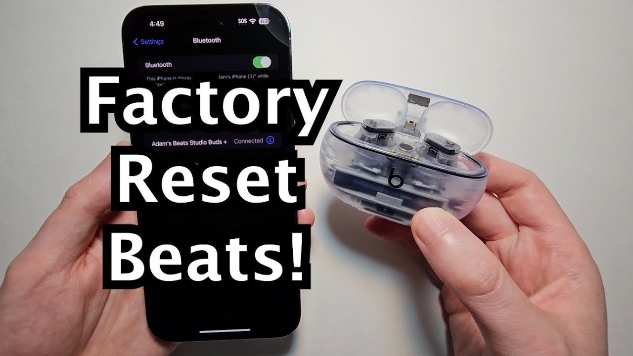 Beats Studio Buds inside their charging case on a white desk ready for reset.
