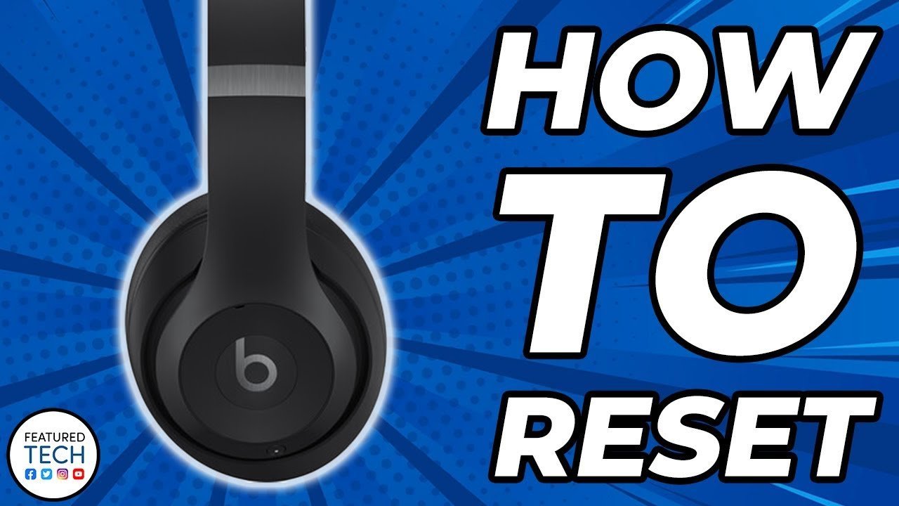 Wireless headphones connected to a charging cable to ensure sufficient power for the reset.