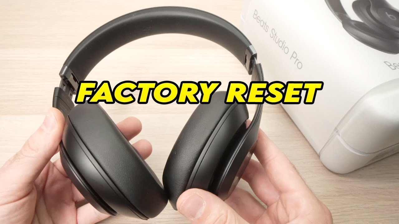 Sleek wireless headphones resting on a desk for a how to reset Beats Studio Pro guide.