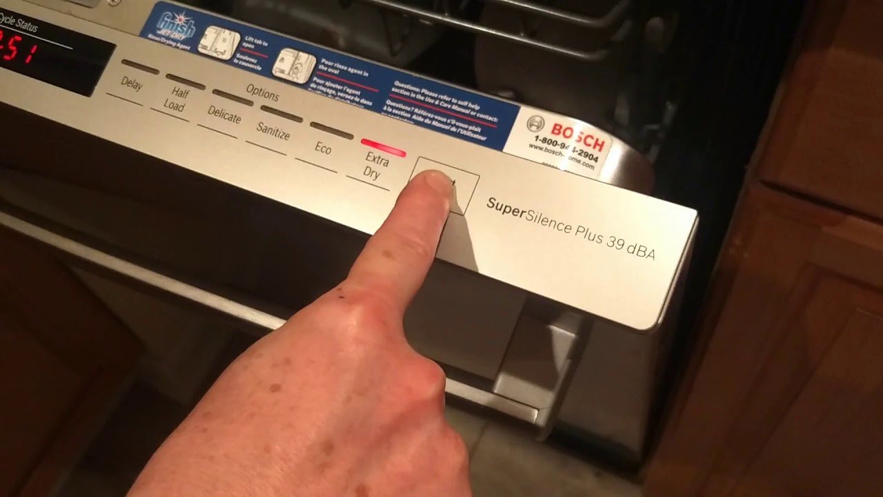 A hand reaching for a wall switch to perform an alternative dishwasher reset.