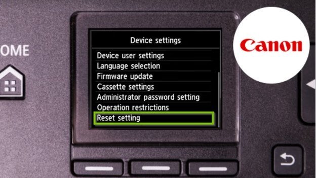 A finger presses the setup button on a Canon printer control panel.