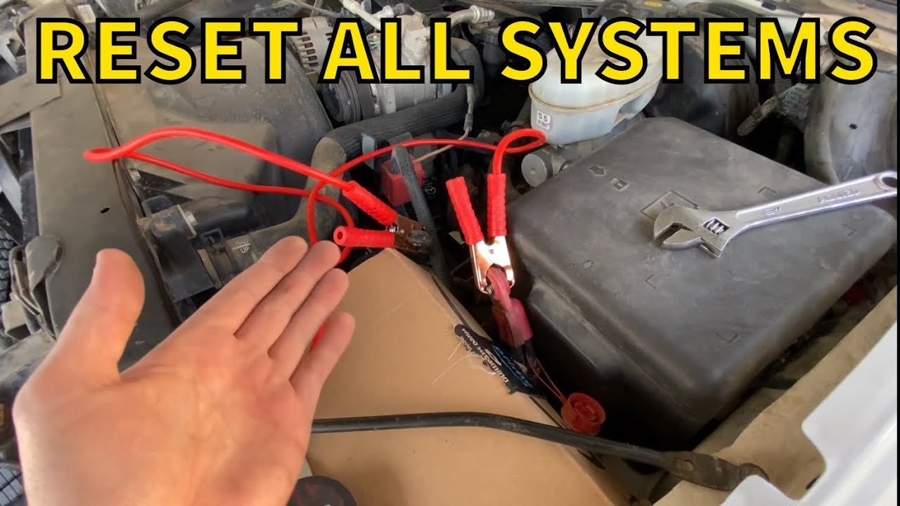 Engine bay view showing the battery and fuse box for different car reset methods.