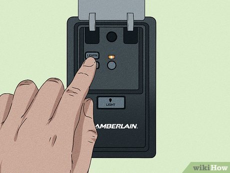 A person accessing the control panel on a garage door opener to clear settings.
