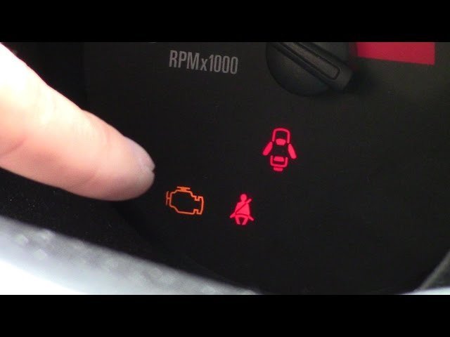 Connecting an OBD2 scanner to the diagnostic port under a car dashboard.