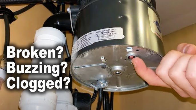 Using a hex key to manually clear a jam inside a garbage disposal unit.