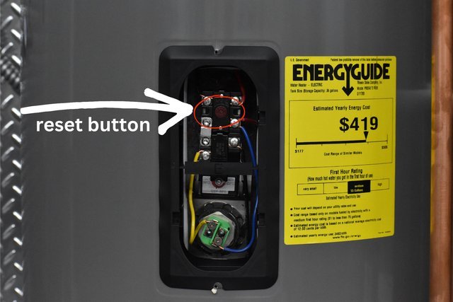 Essential tools for resetting an electric water heater laid out on a workbench.