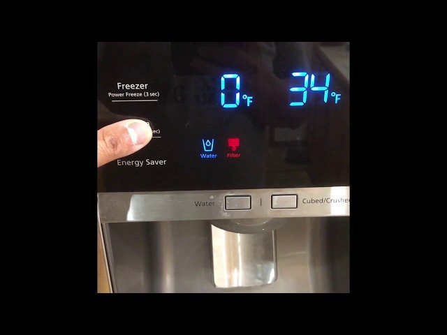 Pressing the internal reset button located inside the refrigerator door frame.