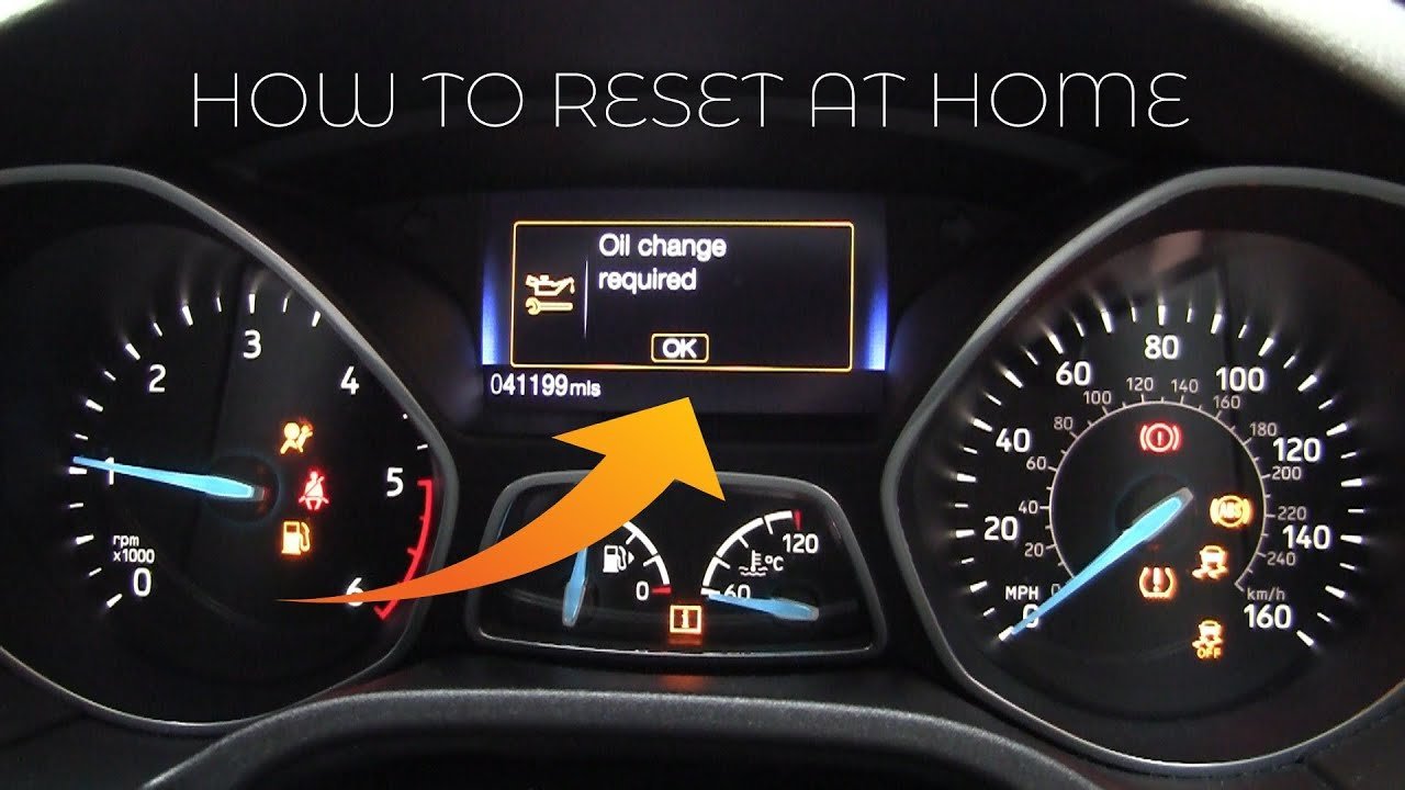 Checking the instrument cluster display during a Ford Focus oil change reset.