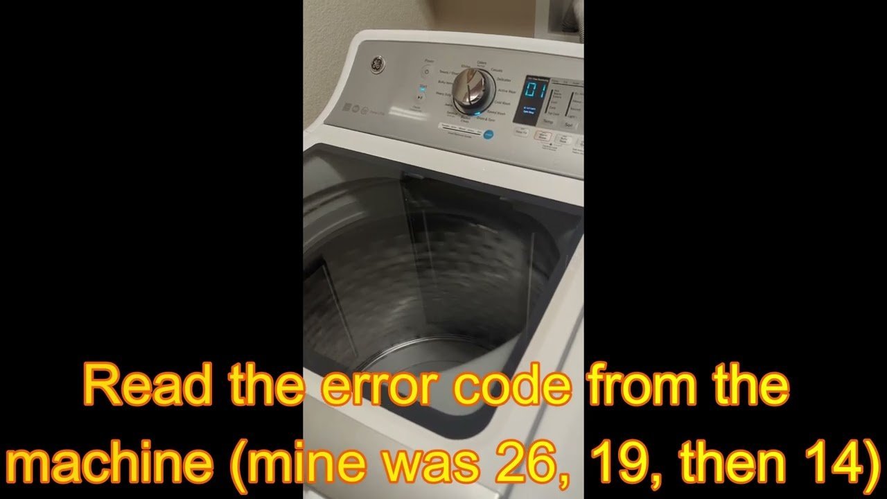 A person interacting with the control panel of a top load washer.