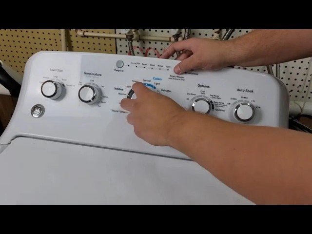 An open electrical breaker box used to reset a top load washer.