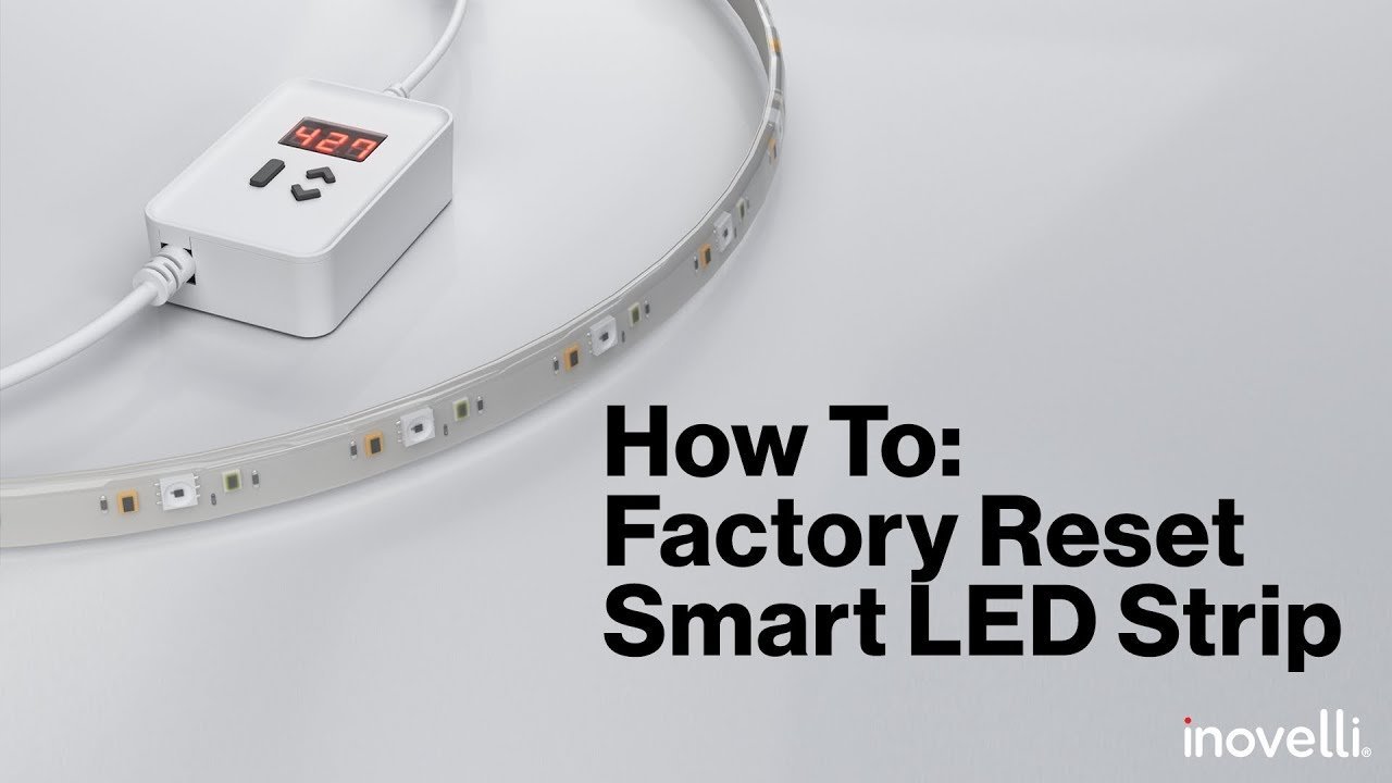 A glowing LED light strip installed on a shelf, controlled by a smartphone app.