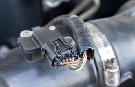 An engine control module inside a vehicle bay representing the idle relearn process.