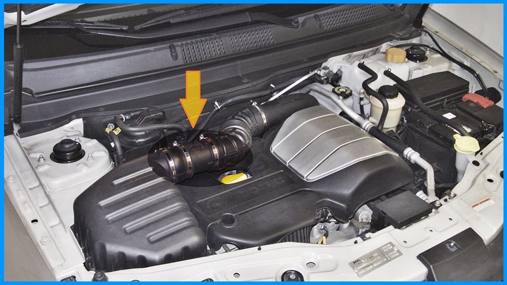 A technician performing an alternate reset method using a multimeter on a car battery.