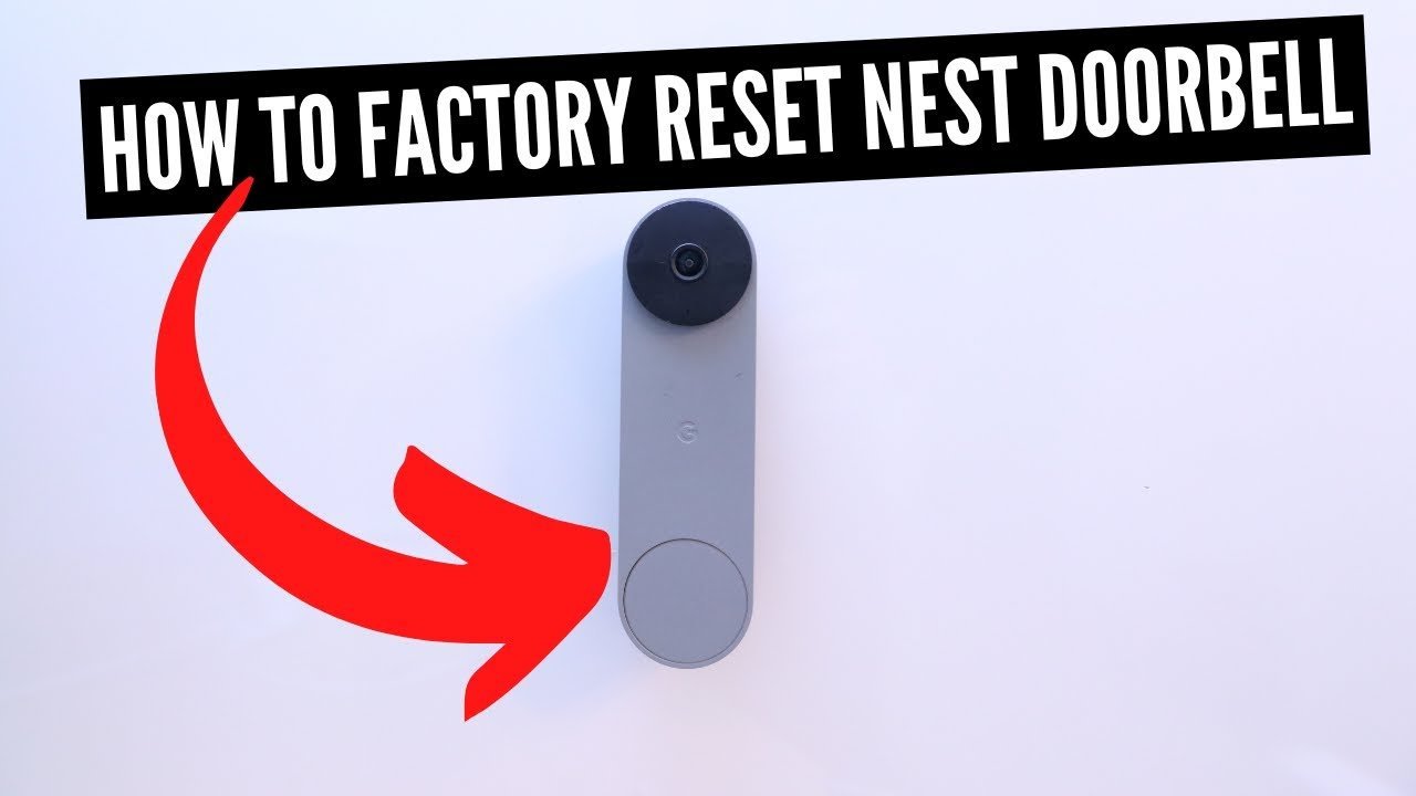 A small tool pressing the reset button on the back of a doorbell.