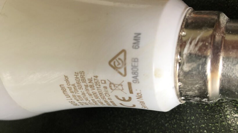 Holding a remote control close to a smart bulb for a reset.