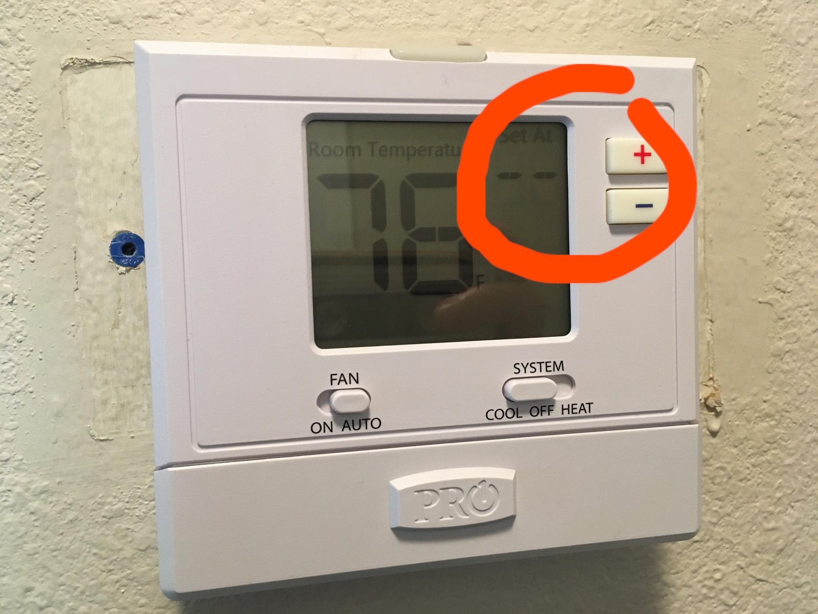 Essential tools like batteries and a coin for performing a thermostat reset.