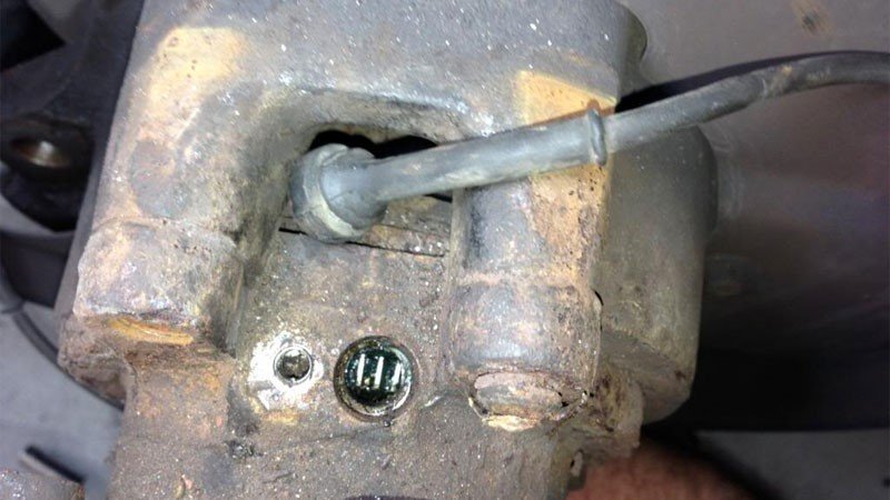 A driver preparing to reset the car ignition system in a quiet garage.