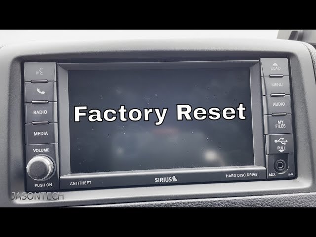 Hands pressing the power and volume buttons on a car dashboard for a reset.