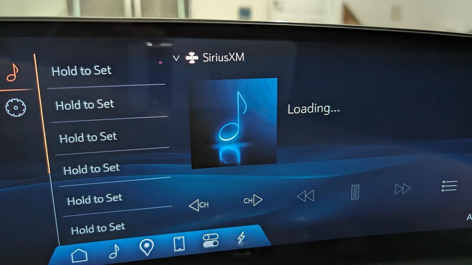 A car infotainment screen displaying an acquiring signal notification during a system reset.