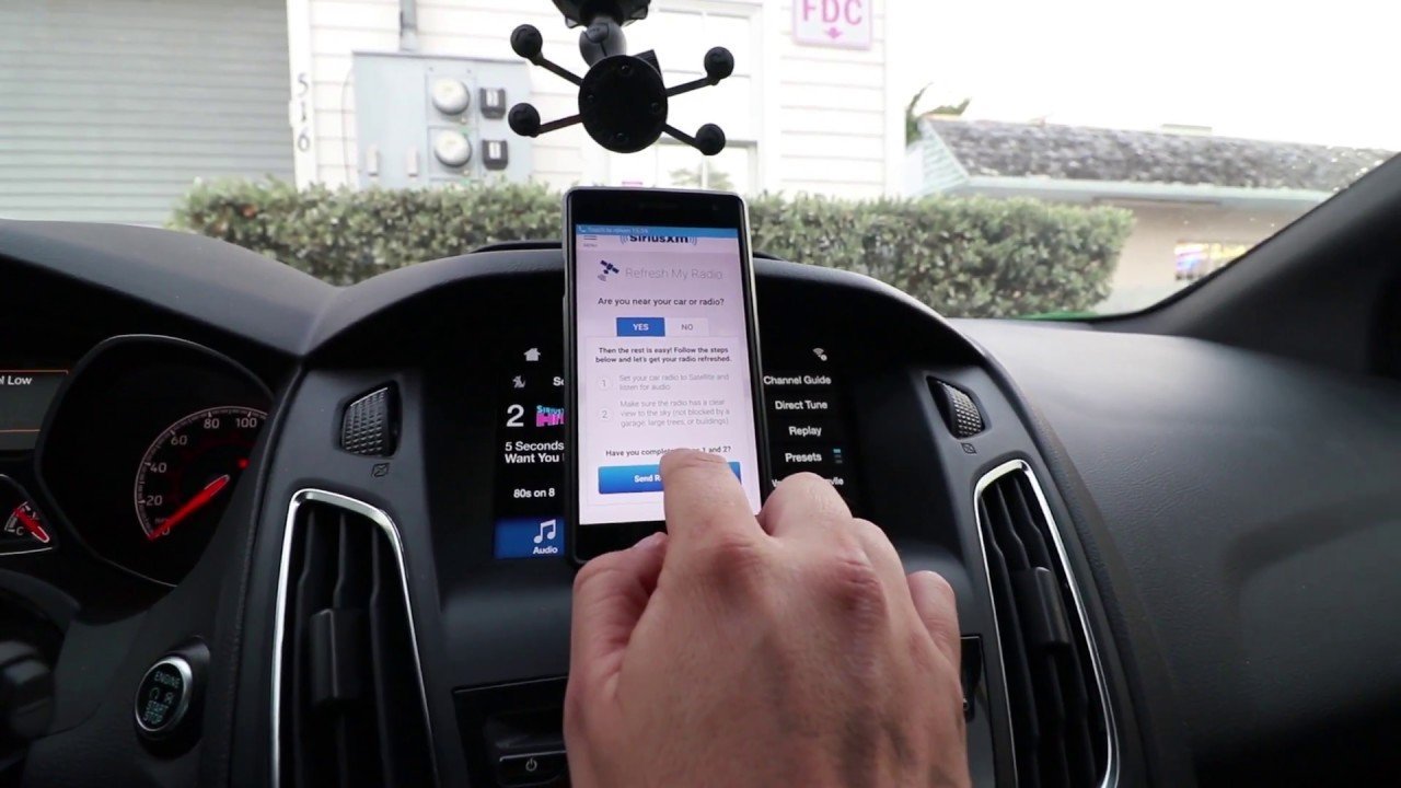 A modern car infotainment screen displaying a satellite radio interface while resetting.