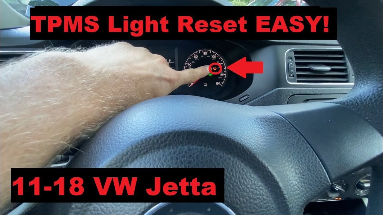 A person measures tire pressure to properly reset the TPMS light on their car.