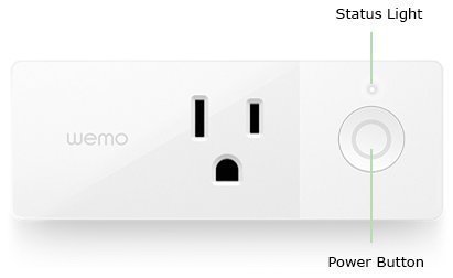 A Wemo smart plug and smartphone laid out for a device reset.