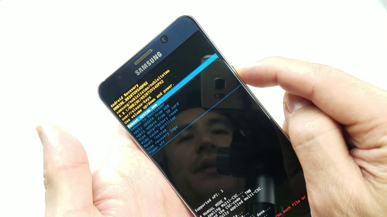 A clean workspace with a smartphone and notebook for troubleshooting phone lock questions.