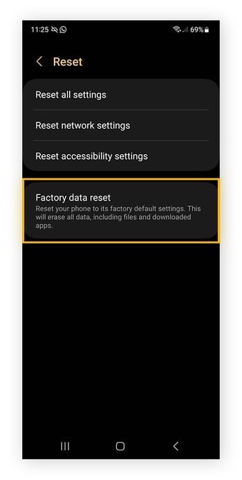 A smartphone plugged into a power source to prevent errors during master reset.